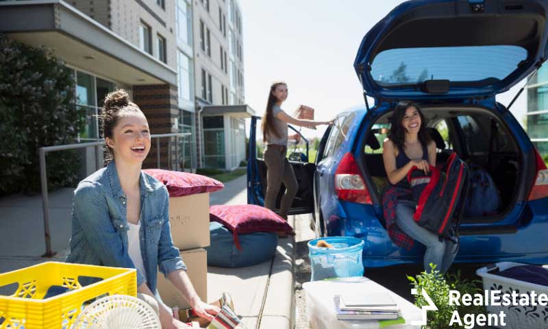 college students unloading car moving