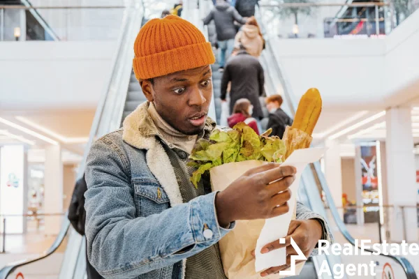 african man paper bag groceries looks