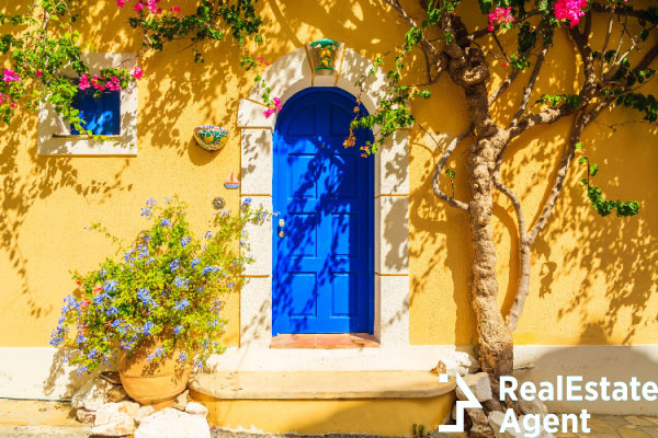 blue door yellow greek house decorated