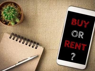 cellphone with rent vs buy text and a notepad