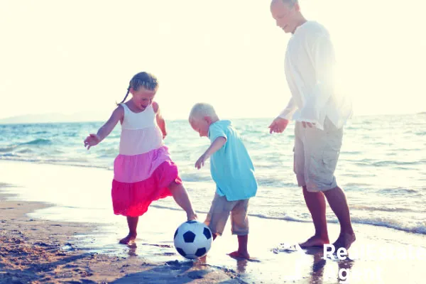 father and daughter on the beach fun