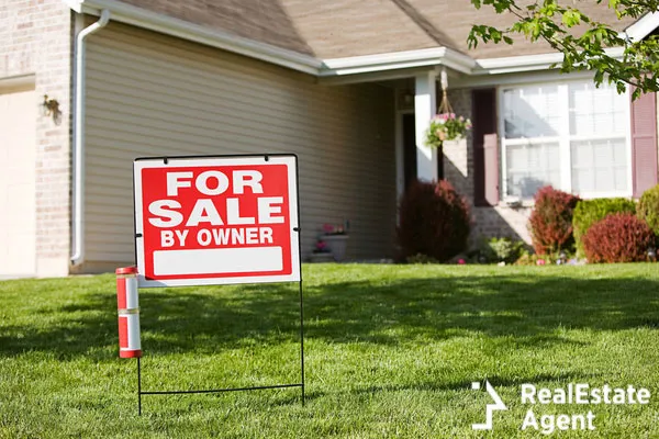 for sale by owner sign on the front of the house