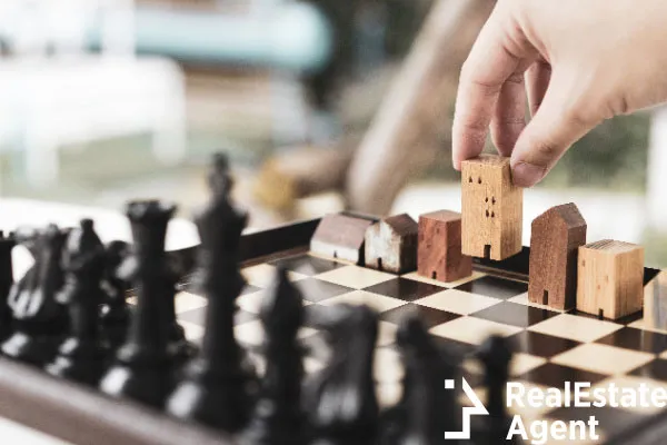 hand man moving chess building