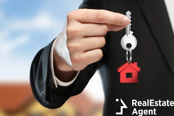 hand handing key on cottage