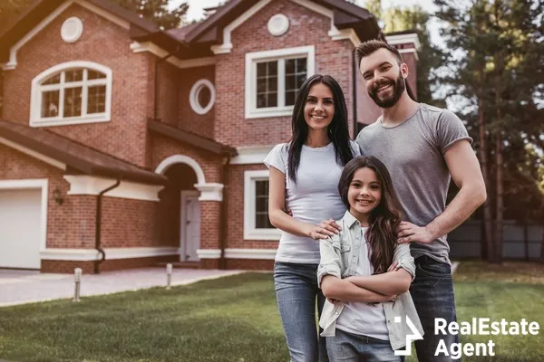 happy family standing near modern house