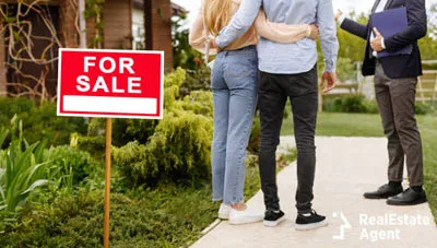 agent showing the house to a young couple