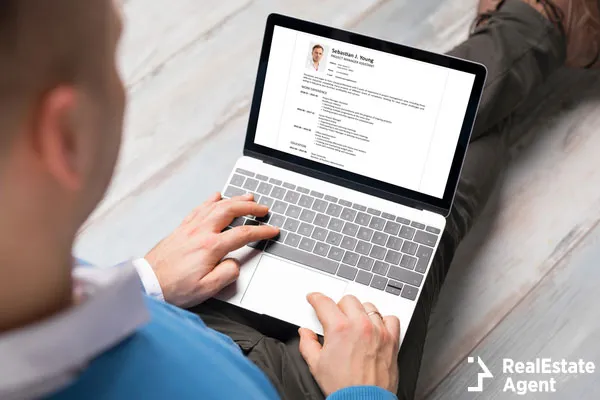 man creating his cv on laptop