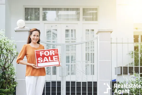 mature woman holding a sale sign