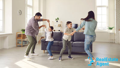 young parents dancing with the kids in the livingroom