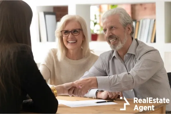 people sitting on desk handshaking