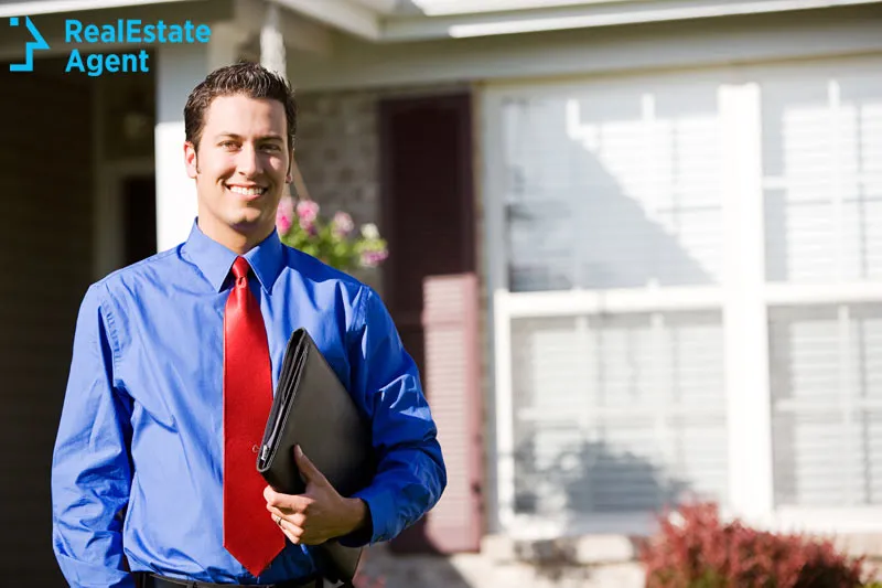 real estate agent in front of a house