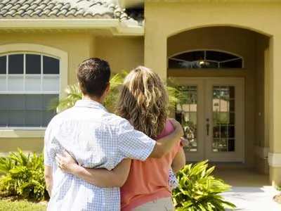 young couple embraced looking at a house