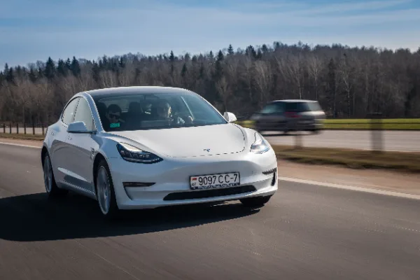 tesla white car on road