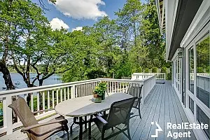 large long balcony home exterior with chairs