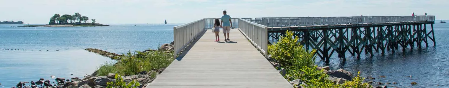 view down the pier of the boardwalk in calf pasture beach norwalk CT