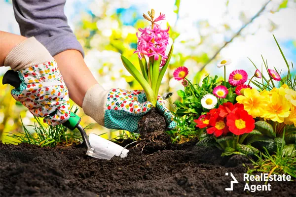 woman wearing pretty gloves as she is gardening