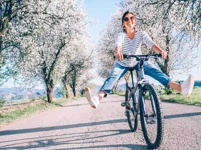 woman ridding bicycle on a beautiful sunny day