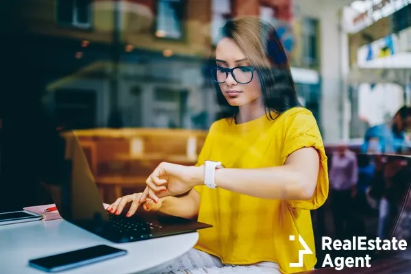 young businesswoman looking at watch