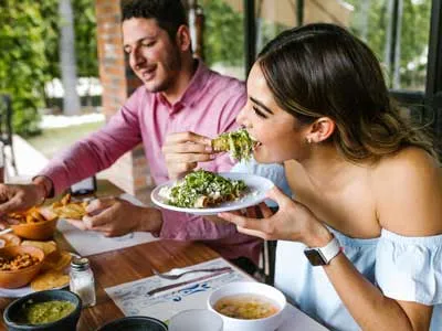 youn couple enjoying a meal at a restaurant