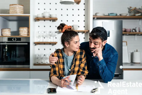 young happy couple standing kitchen