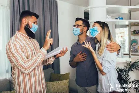 young happy married couple in medical masks standing