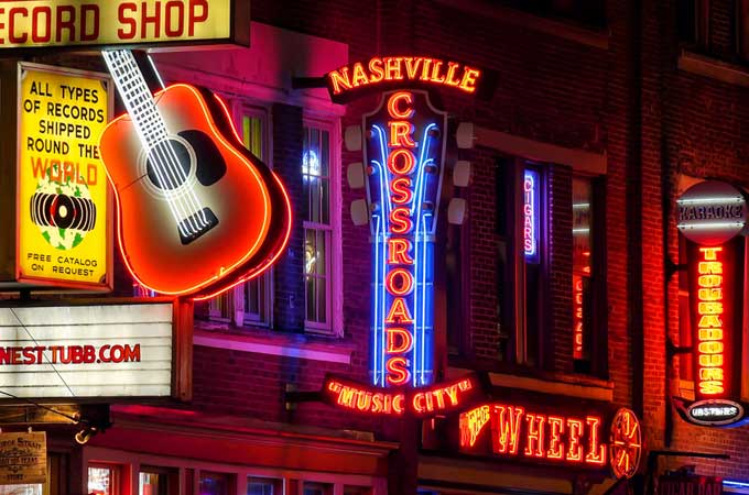 Neon signs at night along Broadway Street in Nashville Tennessee