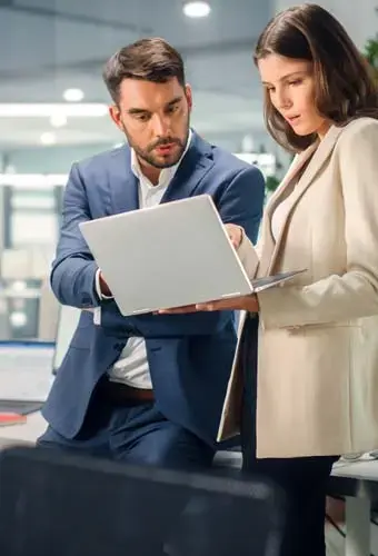 young professional couple looking at laptop